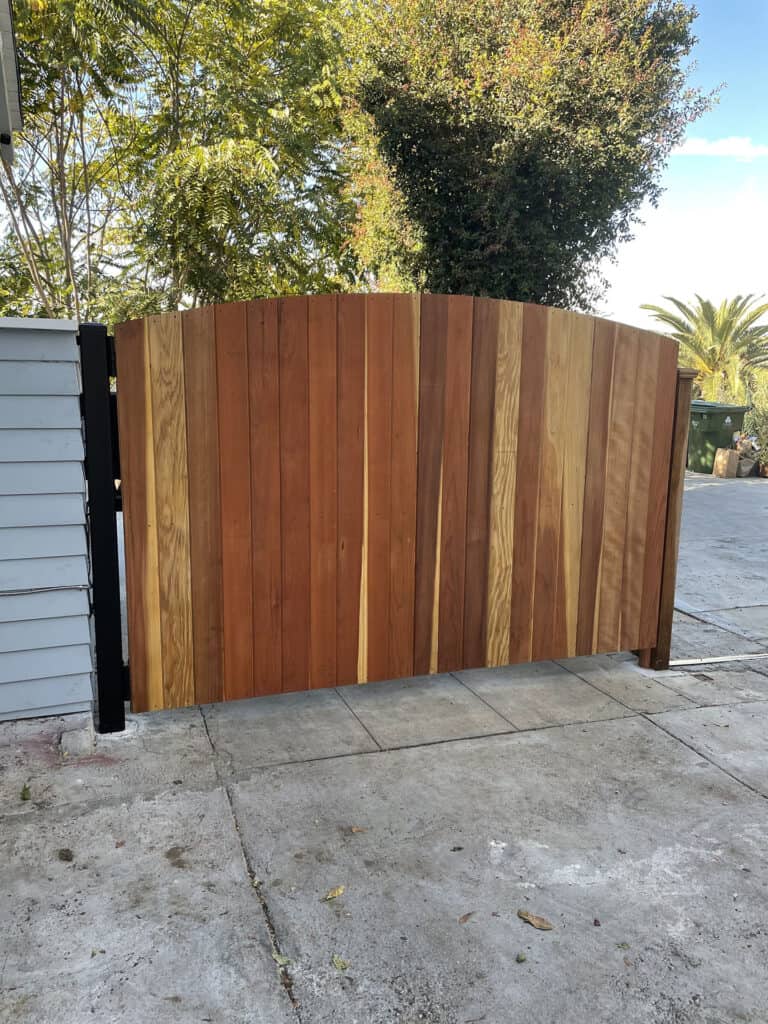 arched redwood plank driveway gate