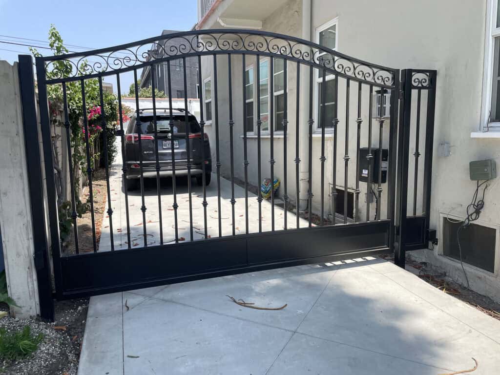 black wrought iron arched driveway gate