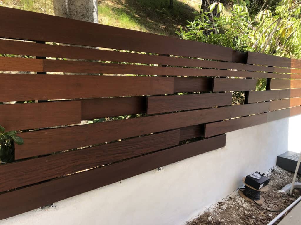 dark walnut horizontal slat fence hillside