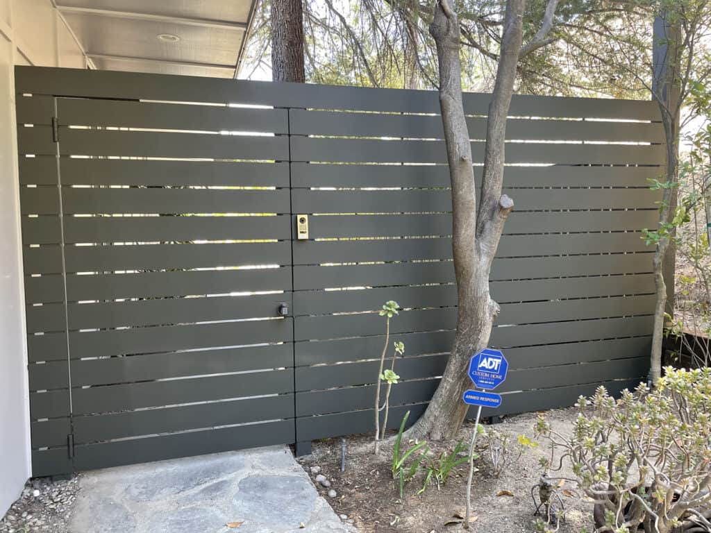 Fencing gray horizontal slat fence with keypad gate