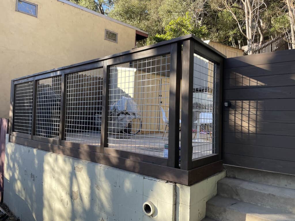hog wire deck railing dark stained wood frame