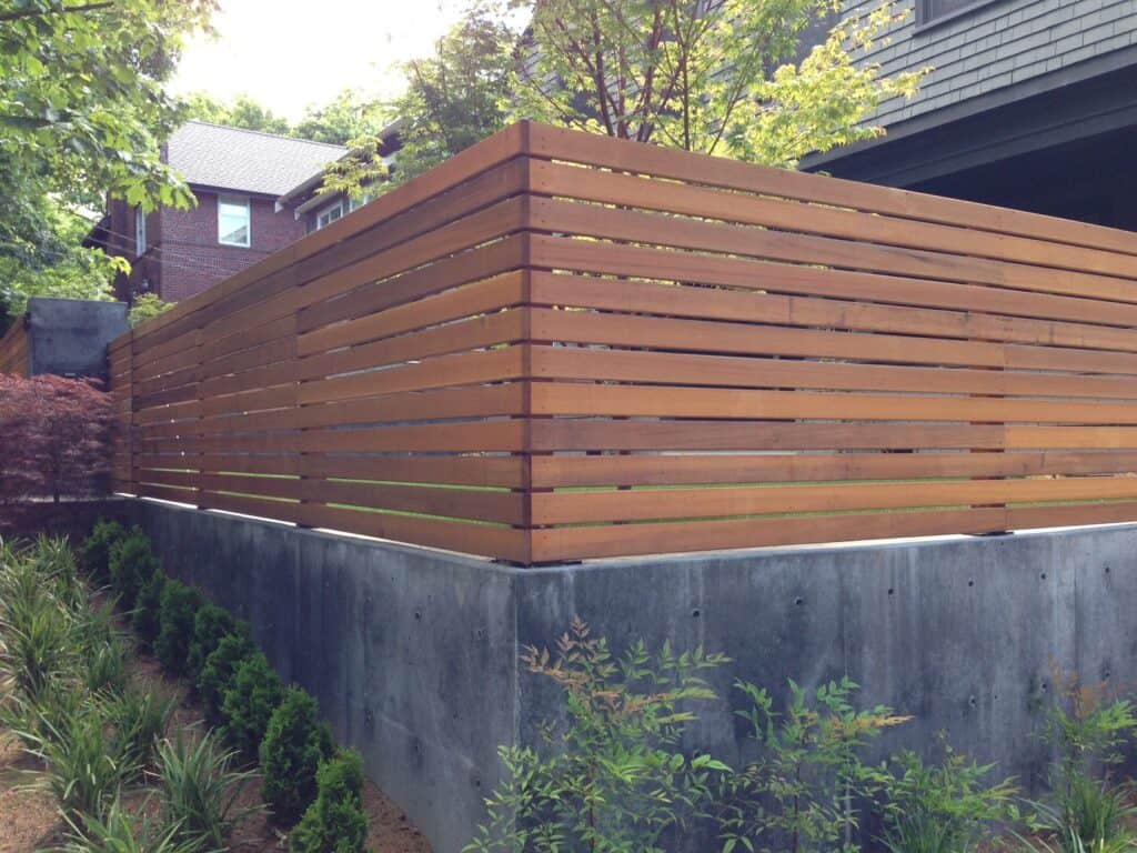 horizontal ipe wood slat fence concrete base