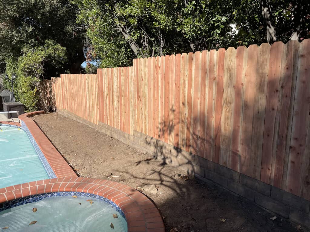 redwood dog ear fence poolside backyard